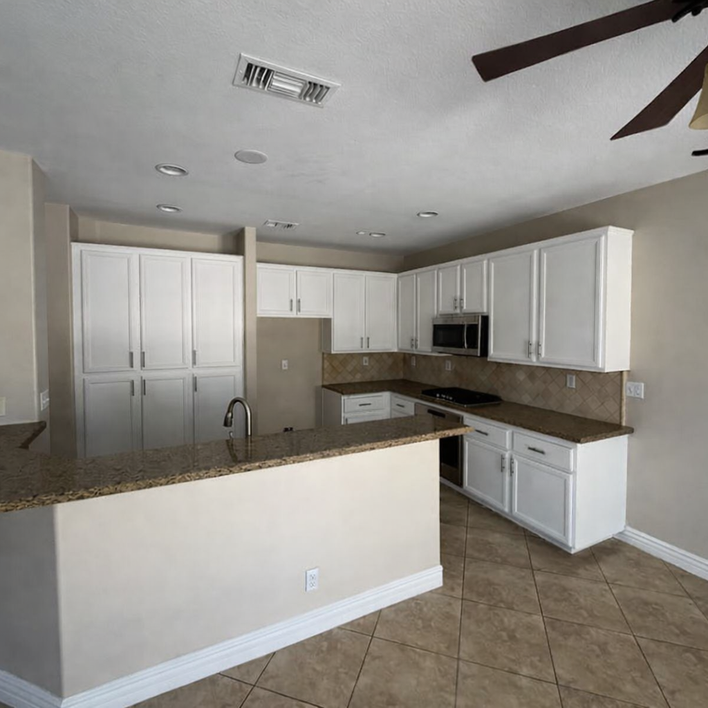 The same kitchen cabinets after being refinished white