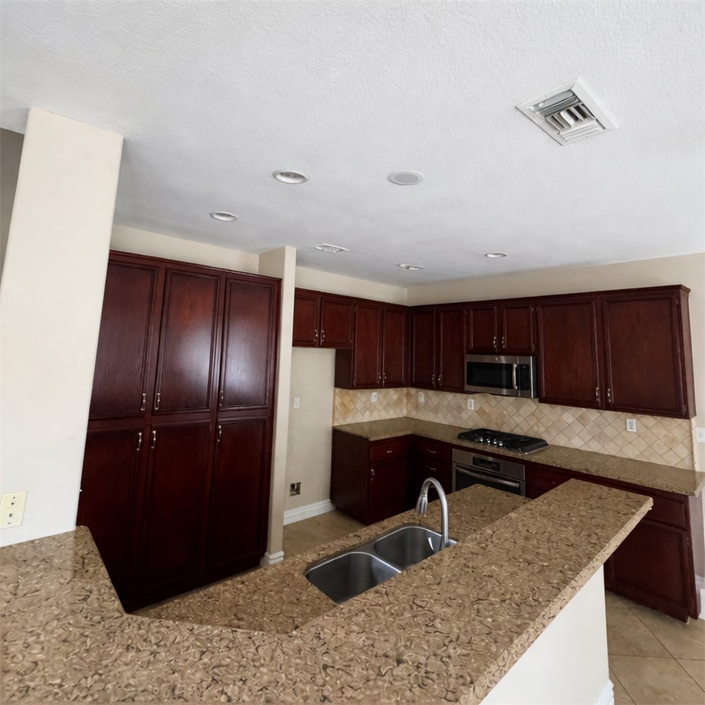 Dark cherry kitchen cabinets before refinishing