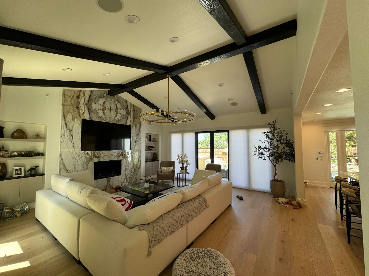 Adjoining living space finished alongside the kitchen: beamed ceiling, stone fireplace, oak floor